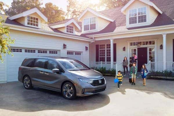 A family with their new vehicle at home